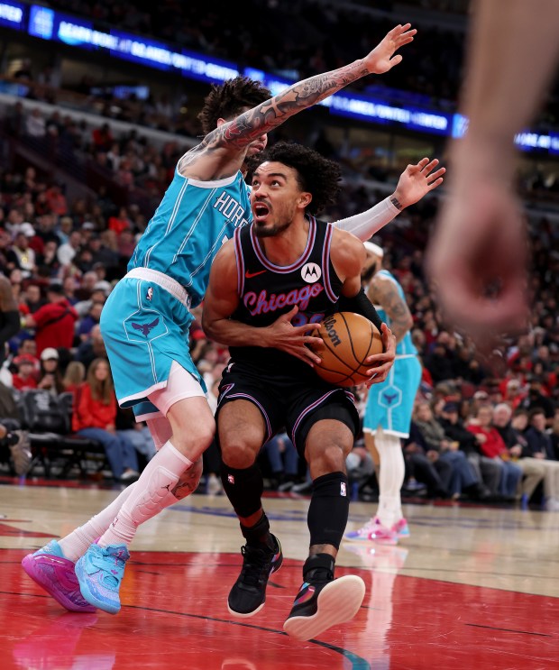 Chicago Bulls guard Tre Jones (30) drives on Charlotte Hornets guard Lamelo Ball (1) in the second half of a game at the United Center in Chicago on Jan. 3, 2026. (Chris Sweda/Chicago Tribune)
