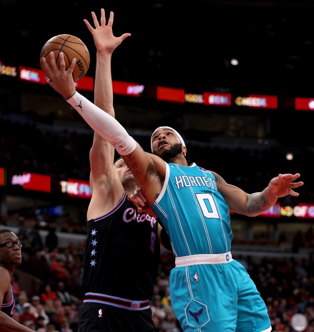 Charlotte Hornets forward Miles Bridges (0) drives on Chicago Bulls center Nikola Vučević (9) in the first half of a game at the United Center in Chicago on Jan. 3, 2026. (Chris Sweda/Chicago Tribune)