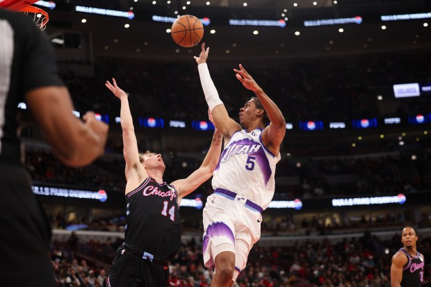Utah Jazz forward Cody Williams (5) goes up for a shot over Chicago Bulls forward Matas Buzelis (14) during the first quarter at the United Center Jan. 14, 2026 in Chicago. (Armando L. Sanchez/Chicago Tribune)