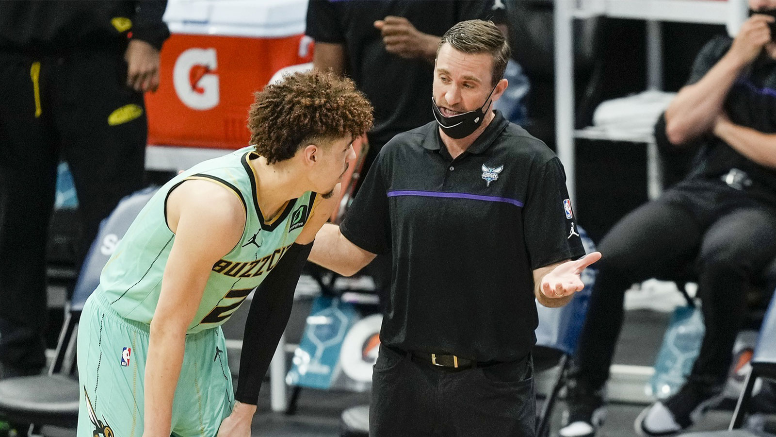 Charlotte Hornets guard LaMelo Ball (L) talks with assistant coach Chad Iske (R) during a time out during the fourth quarter against the Denver Nuggets at the Spectrum Center.