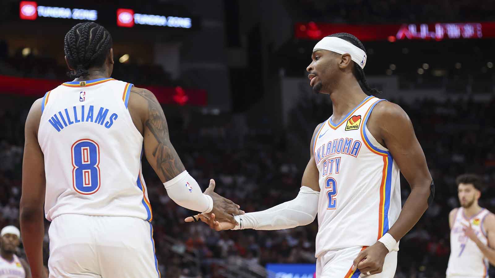 Oklahoma City Thunder guard Jalen Williams (8) and guard Shai Gilgeous-Alexander (2) react after a play during the third quarter against the Houston Rockets at Toyota Center.