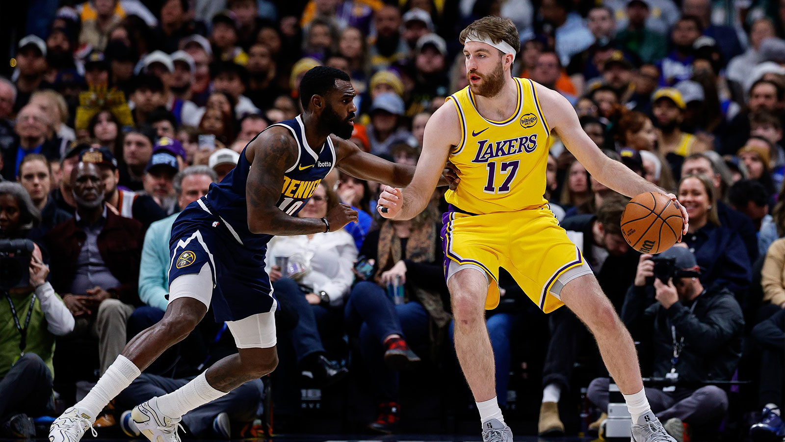 Los Angeles Lakers forward Drew Timme (17) controls the ball as Denver Nuggets guard Tim Hardaway Jr. (10) guards in the second quarter at Ball Arena.