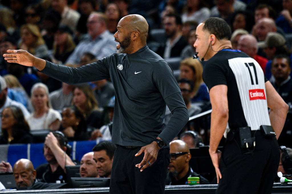 Orlando Magic head coach Jamahl Mosley, left, argues a call with official Jonathan Sterling (17) during the first half of an NBA basketball game against the Cleveland Cavaliers, Saturday, Jan. 24, 2026, in Orlando, Fla. (AP Photo/Phelan M. Ebenhack)