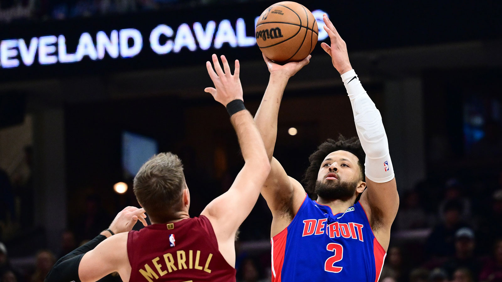 Detroit Pistons guard Cade Cunningham (2) shoots over the defense of Cleveland Cavaliers guard Sam Merrill (5) during the first half at Rocket Arena.