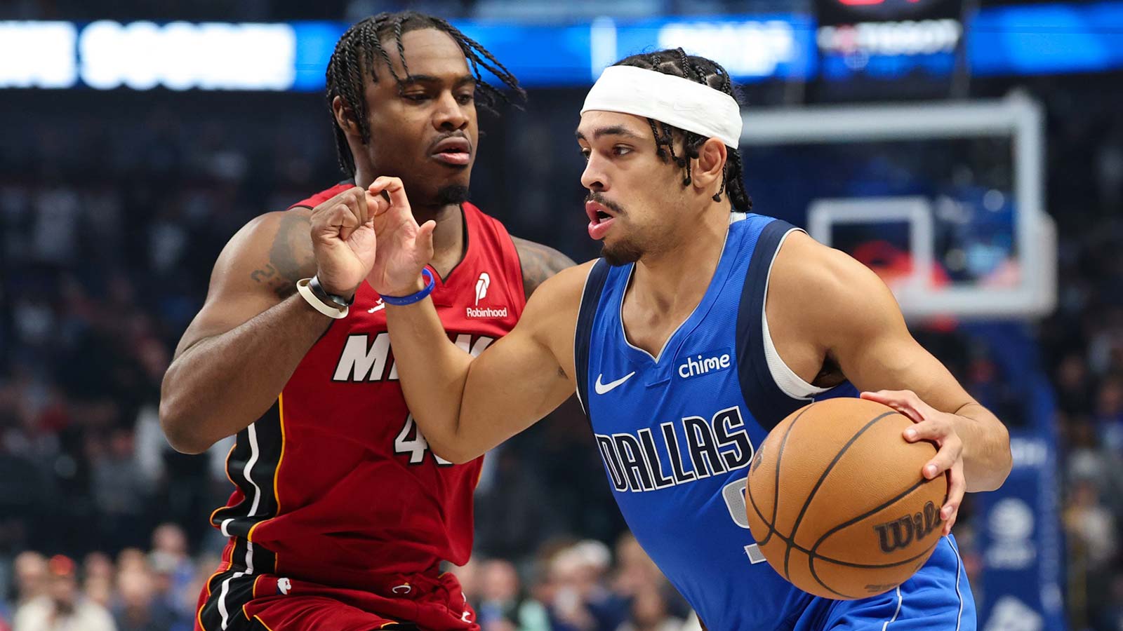 Dallas Mavericks guard Ryan Nembhard (9) drives to the basket as Miami Heat guard Davion Mitchell (45) defends during the first quarter at American Airlines Center.