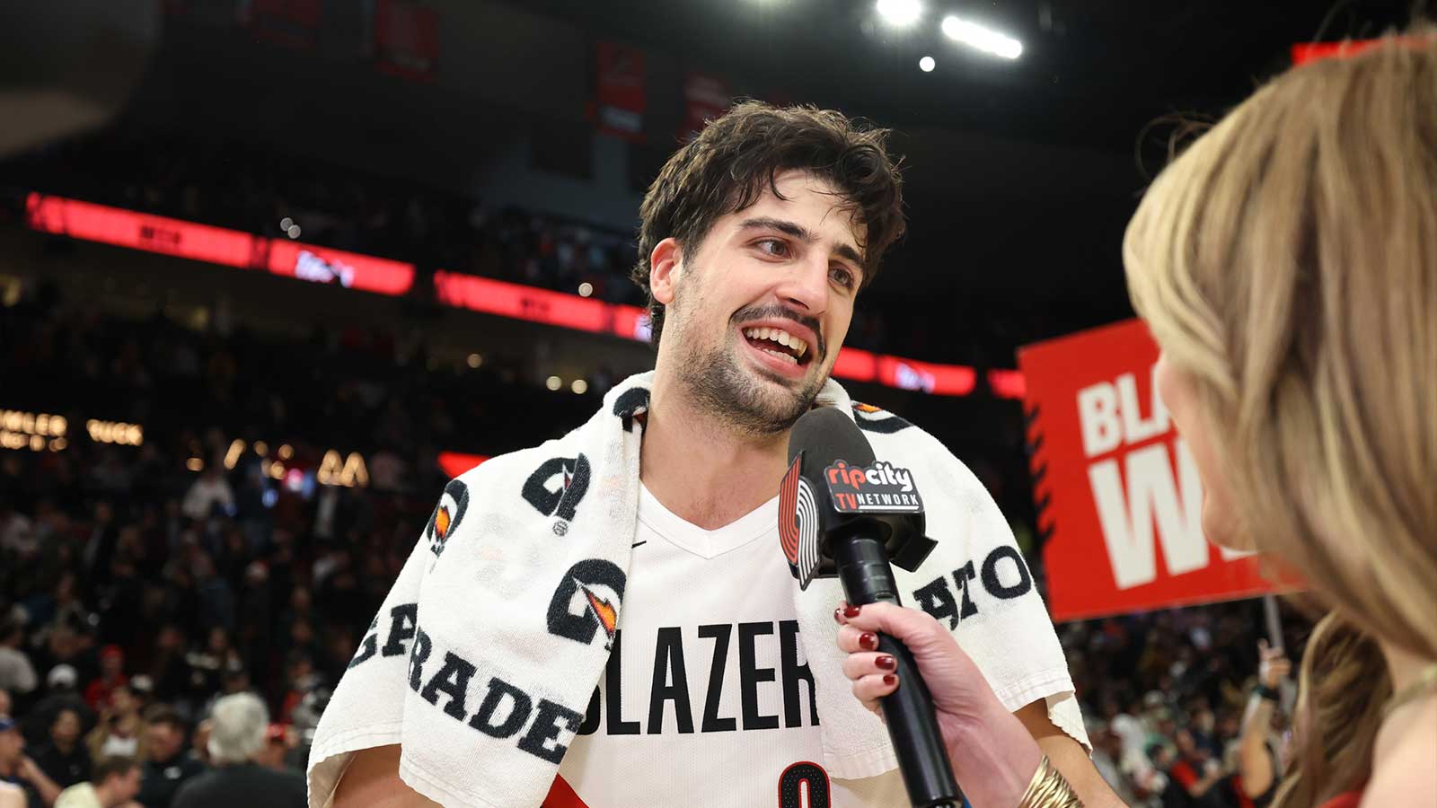 Portland Trail Blazers forward Deni Avdija (8) reacts while being interviewed by Brooke Olzendam after Trail Blazers defeating Houston Rockets 103-102 at Moda Center.