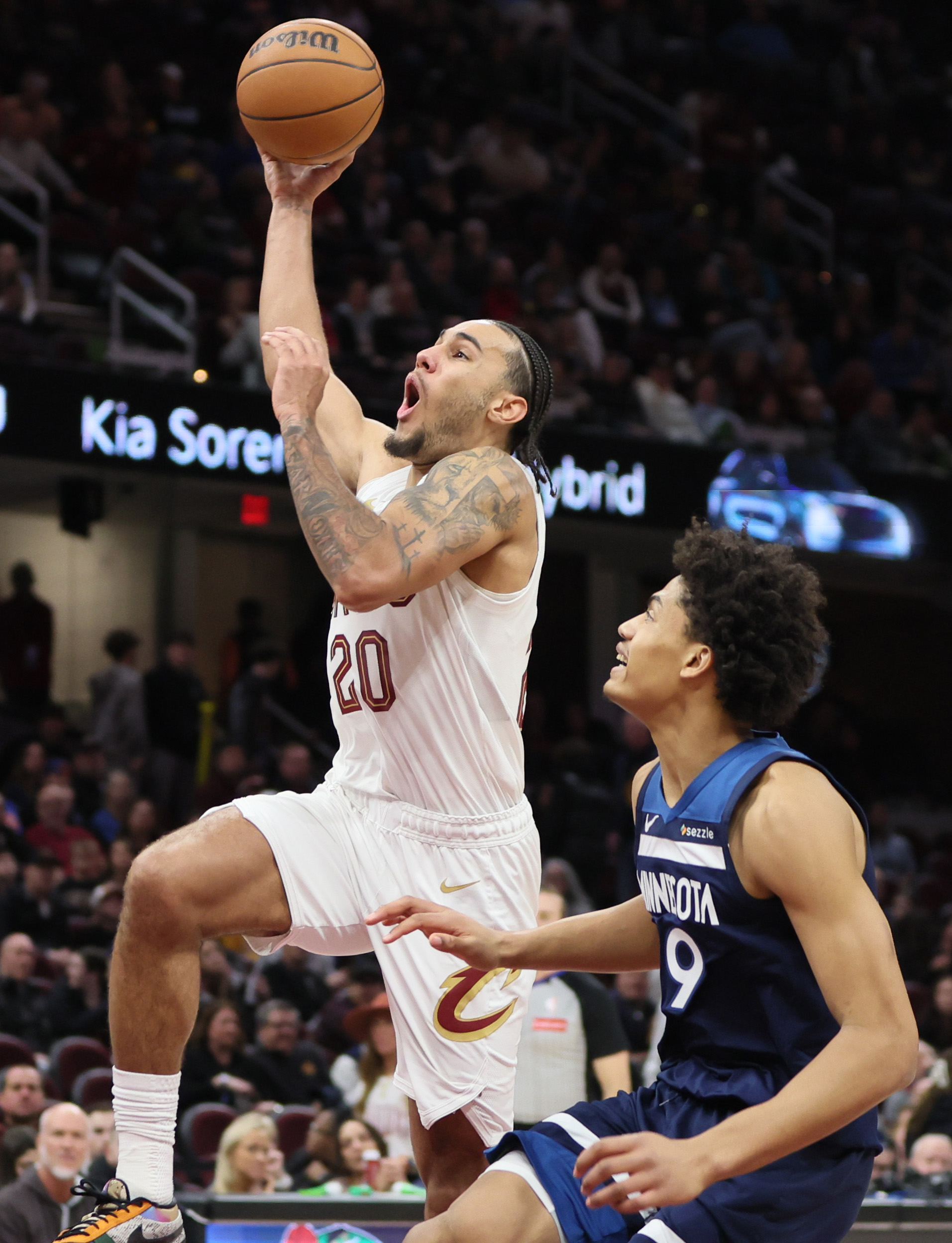 Cleveland Cavaliers guard Jaylon Tyson leaps in the air for a dunk attempt guarded by Minnesota Timberwolves guard Johnny Juzang in the second half. 