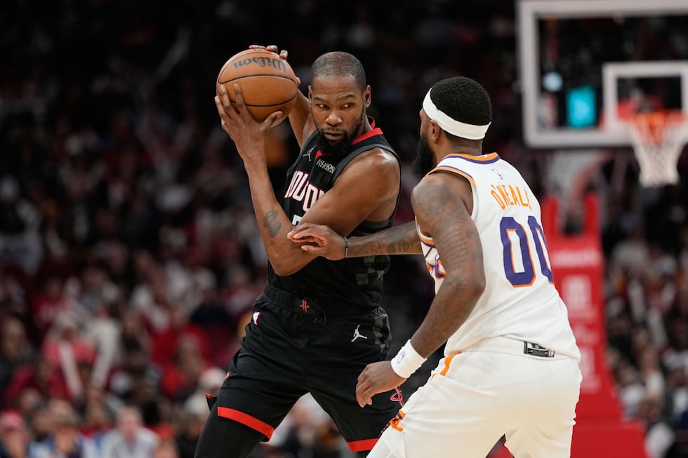 Houston Rockets' Kevin Durant, left, is defended by Phoenix Suns' Royce O'Neale (00) during...