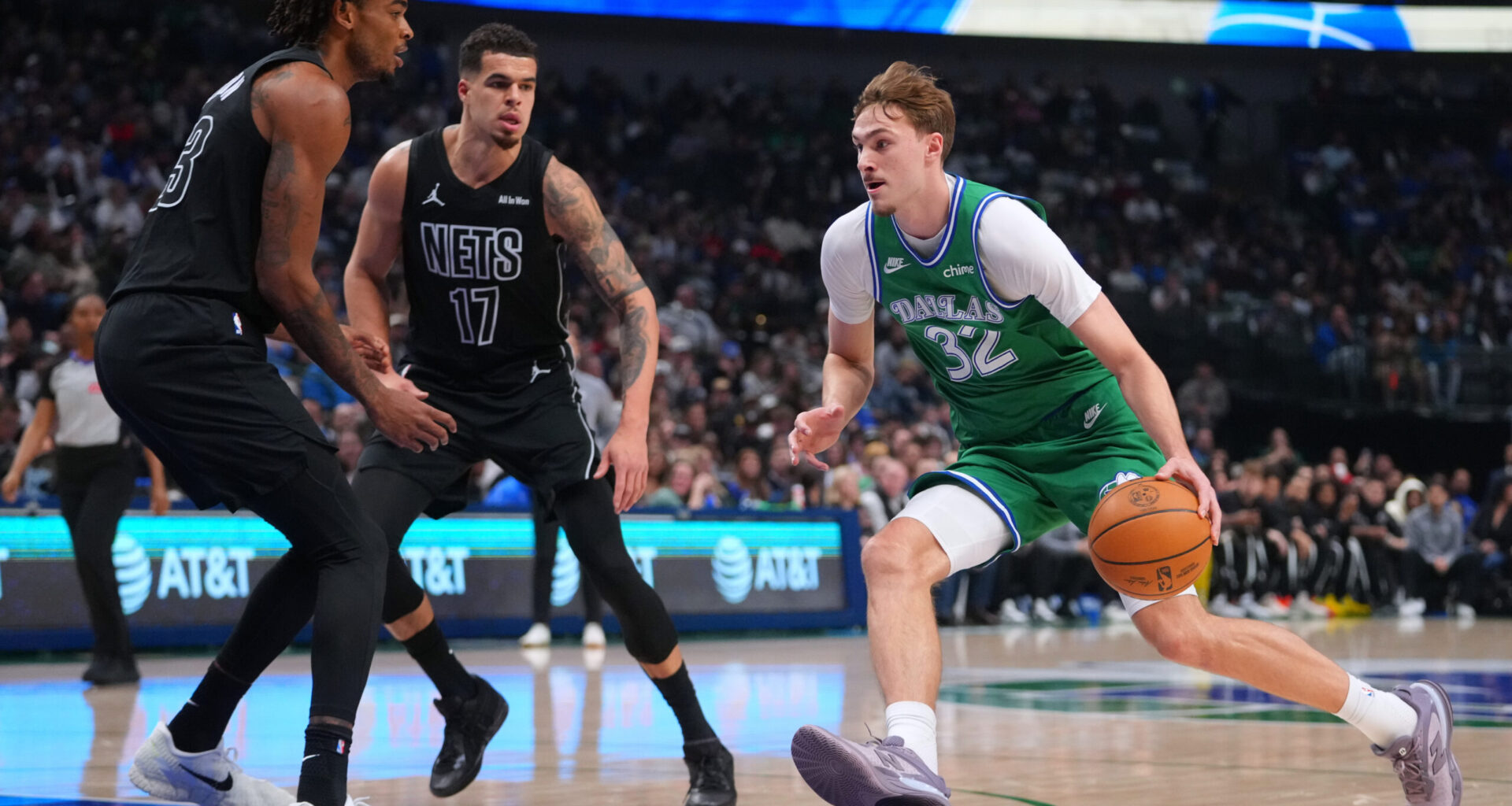 Dallas Mavericks forward Cooper Flagg (32) drives to the basket against Brooklyn Nets forward Michael Porter Jr. (17) and center Nic Claxton during the first half of an NBA basketball game Monday, Jan. 12, 2026, in Dallas. (AP Photo/Julio Cortez)