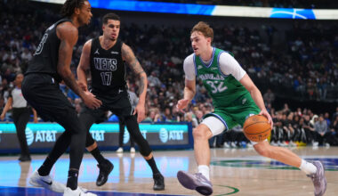 Dallas Mavericks forward Cooper Flagg (32) drives to the basket against Brooklyn Nets forward Michael Porter Jr. (17) and center Nic Claxton during the first half of an NBA basketball game Monday, Jan. 12, 2026, in Dallas. (AP Photo/Julio Cortez)