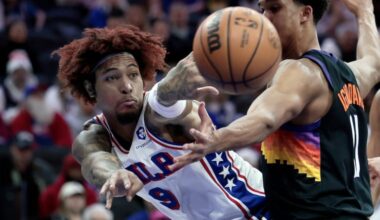 Sixers # 9 Kelly Oubre Jr. passes the ball around Suns # 11 Oso Ighodaro in the first half of the Phoenix Suns vs. Philadelphia 76ers (Sixers) NBA game at Xfinity Mobile Arena in Philadelphia on Tuesday, Jan. 20, 2026.