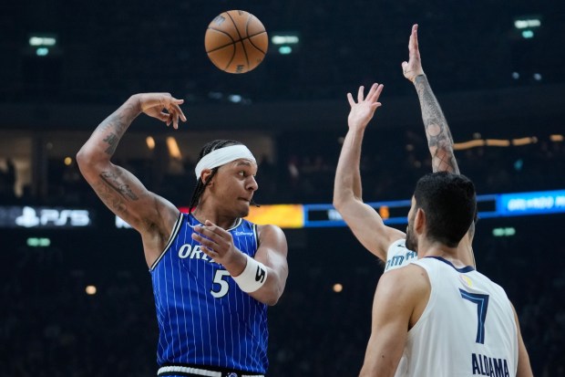 Orlando Magic forward Paolo Banchero (5) passes the ball during an NBA basketball game between Orlando Magic and Memphis Grizzlies in Berlin, Germany, Thursday, Jan. 15, 2026. (AP Photo/Ebrahim Noroozi)