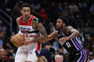 WASHINGTON, DC - MARCH 21: Kyle Kuzma #33 of the Washington Wizards drives to the basket in front of Malik Monk #0 of the Sacramento Kings during the first half at Capital One Arena on March 21, 2024 in Washington, DC. NOTE TO USER: User expressly acknowledges and agrees that, by downloading and or using this photograph, User is consenting to the terms and conditions of the Getty Images License Agreement. (Photo by Patrick Smith/Getty Images)