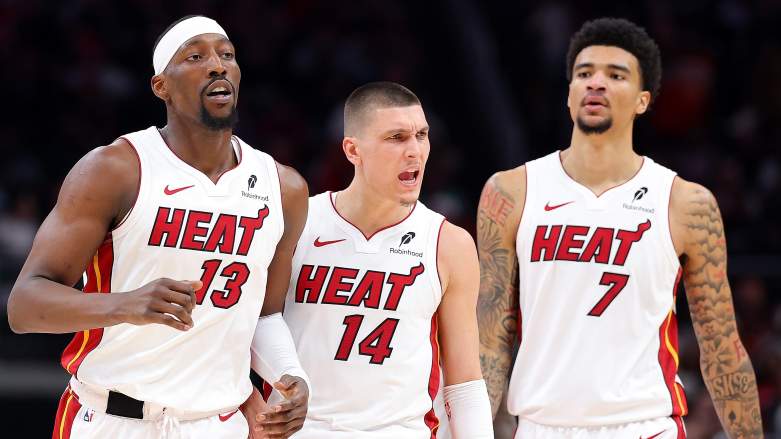 Miami Heat centers Bam Adebayo and Kel'el Ware with guard Tyler Herro
