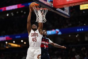 WASHINGTON, DC - DECEMBER 12: Donovan Mitchell #45 of the Cleveland Cavaliers goes to the basket against Jamir Watkins #5 of the Washington Wizards during the second half at Capital One Arena on December 12, 2025 in Washington, DC.