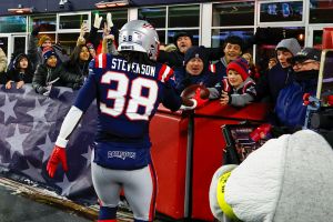 FOXBOROUGH, MA - JANUARY 04: Rhamondre Stevenson #38 of the New England Patriots hands a touchdown ball to a young fan during a game between the New England Patriots and the Miami Dolphins on January 4, 2026, at Gillette Stadium in Foxborough, Massachusetts. (Photo by Fred Kfoury III/Icon Sportswire via Getty Images)