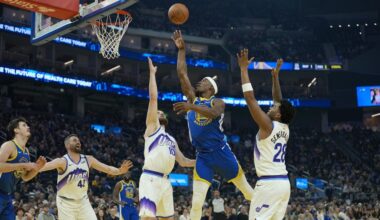 Jimmy Butler III #10 of the Golden State Warriors shoots over Svi Mykhailiuk #10 of the Utah Jazz...