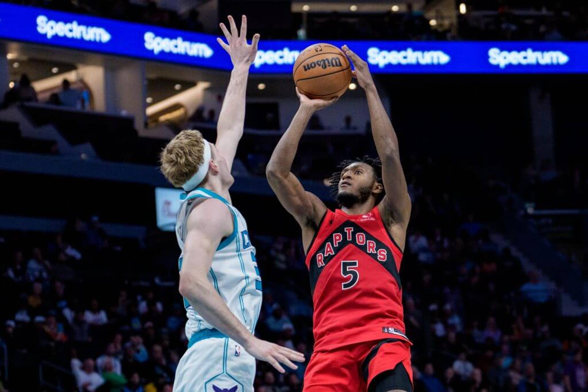 Immanuel Quickley (5) of the Toronto Raptors shoots the ball while guarded by Liam McNeeley #33 of the Charlotte Hornets in the second half during their game at Spectrum Center on Jan. 07, 2026.