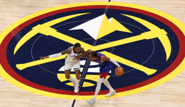 DENVER, COLORADO - JANUARY 11: Kevin Porter Jr. #7 of the Milwaukee Bucks defends Peyton Watson #8 ...