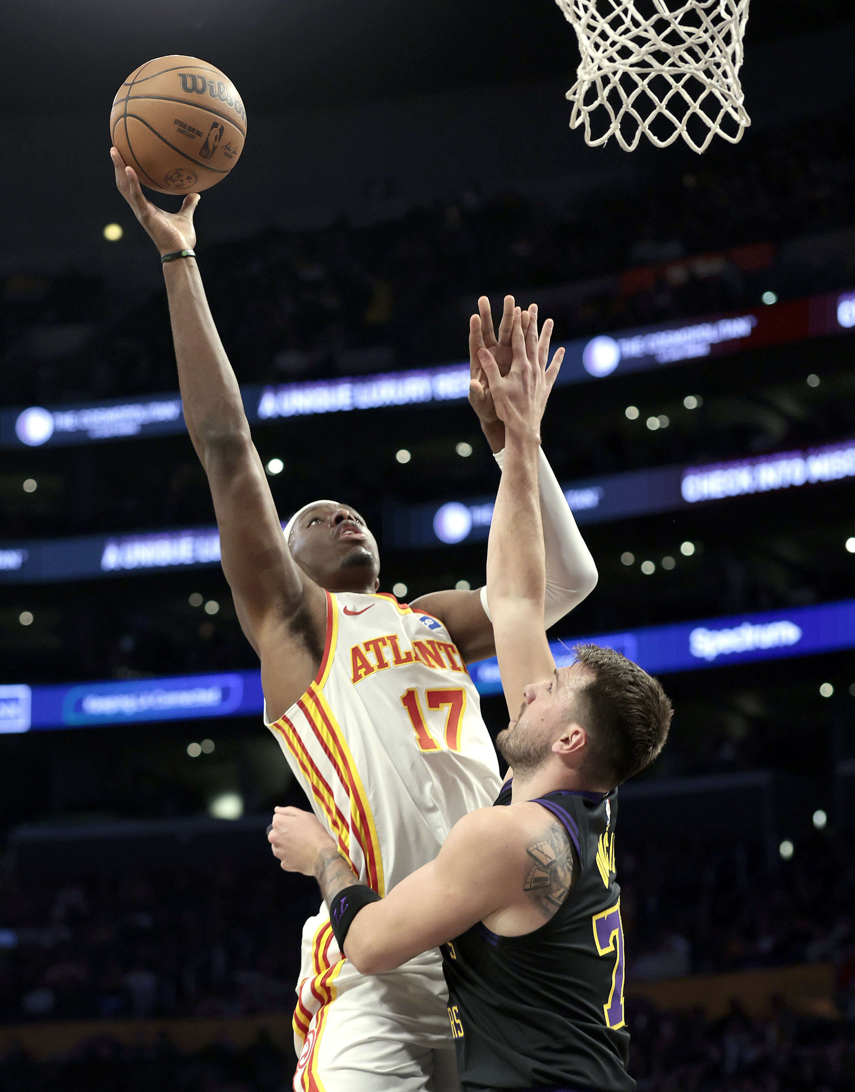 Atlanta Hawks forward Onyeka Okongwu, left, takes a shot as...