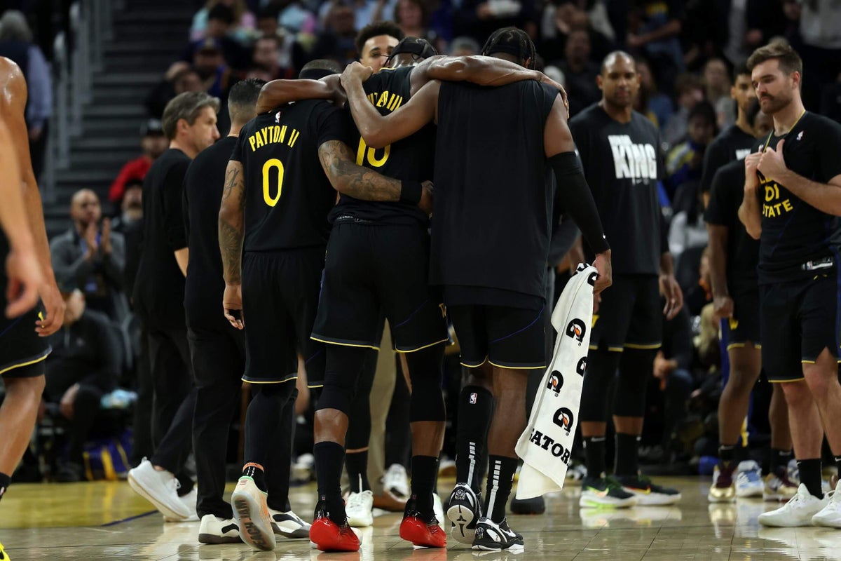 Warriors’ Jimmy Butler helped off after suffering knee injury in win over Heat