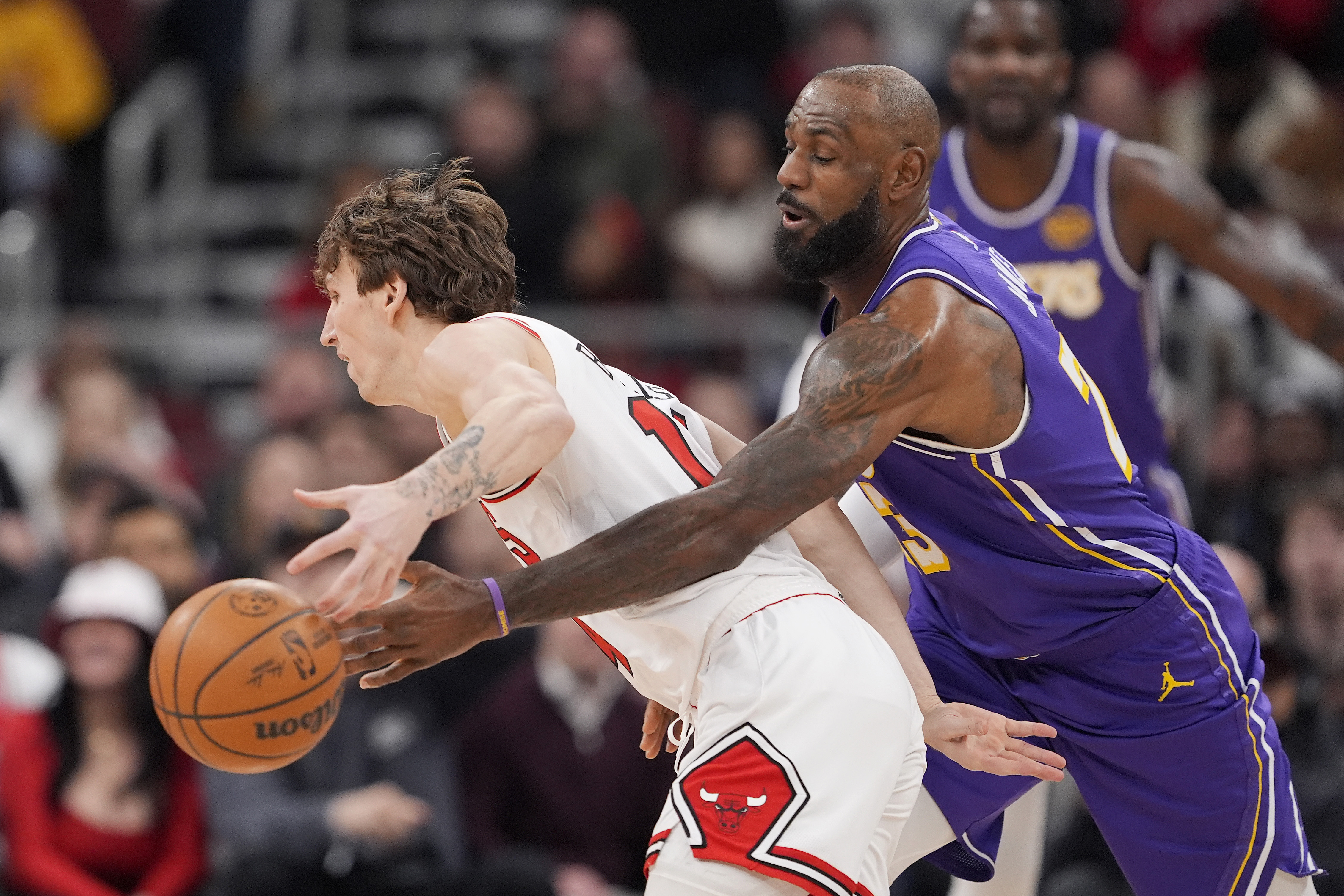 Lakers star LeBron James knocks the ball away from the...