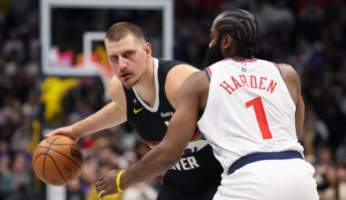 DENVER, COLORADO - JANUARY 30: Nikola Jokic #15 of the Denver Nuggets dribbles as James Harden #1 o...