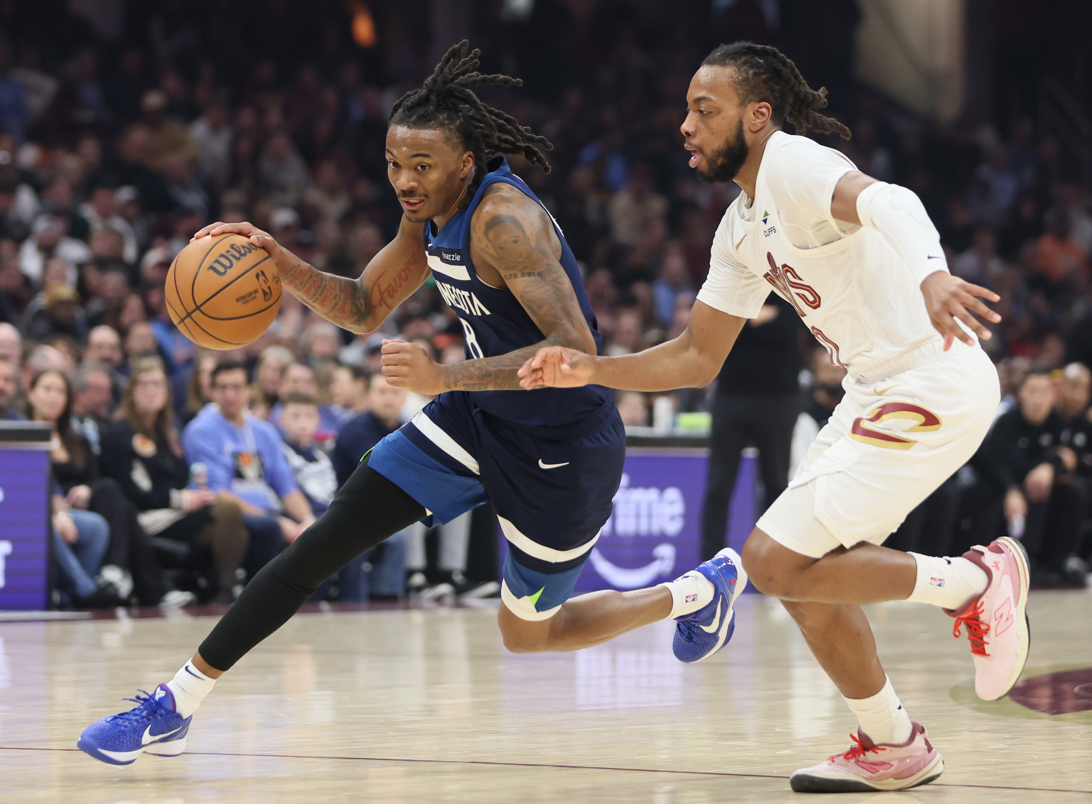 Minnesota Timberwolves guard Bones Hyland drives towards the basket guarded by Cleveland Cavaliers guard Darius Garland in the first half at Rocket Arena. 