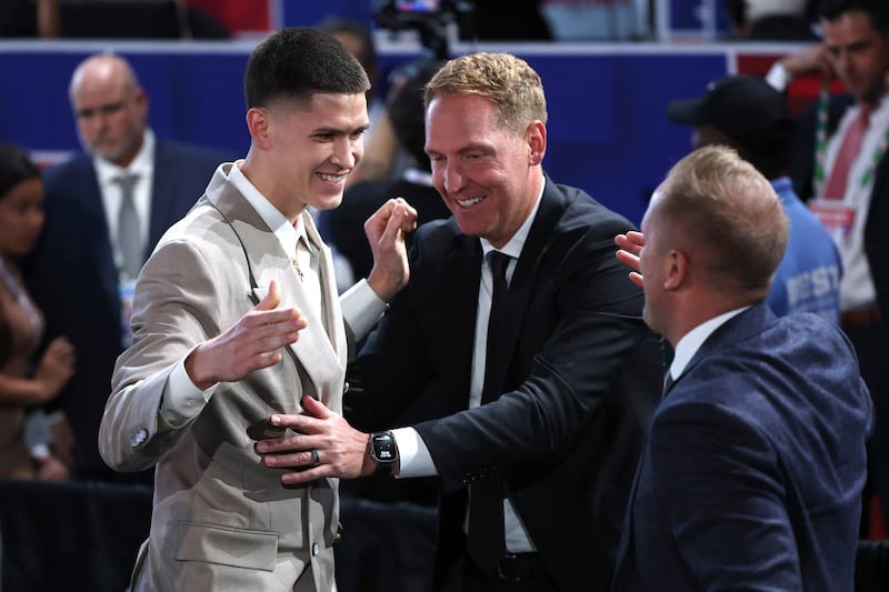 Former BYU star Egor Demin, left, is congratulated by Travis Hansen at the 2025 NBA draft Thursday, June 26, 2025.