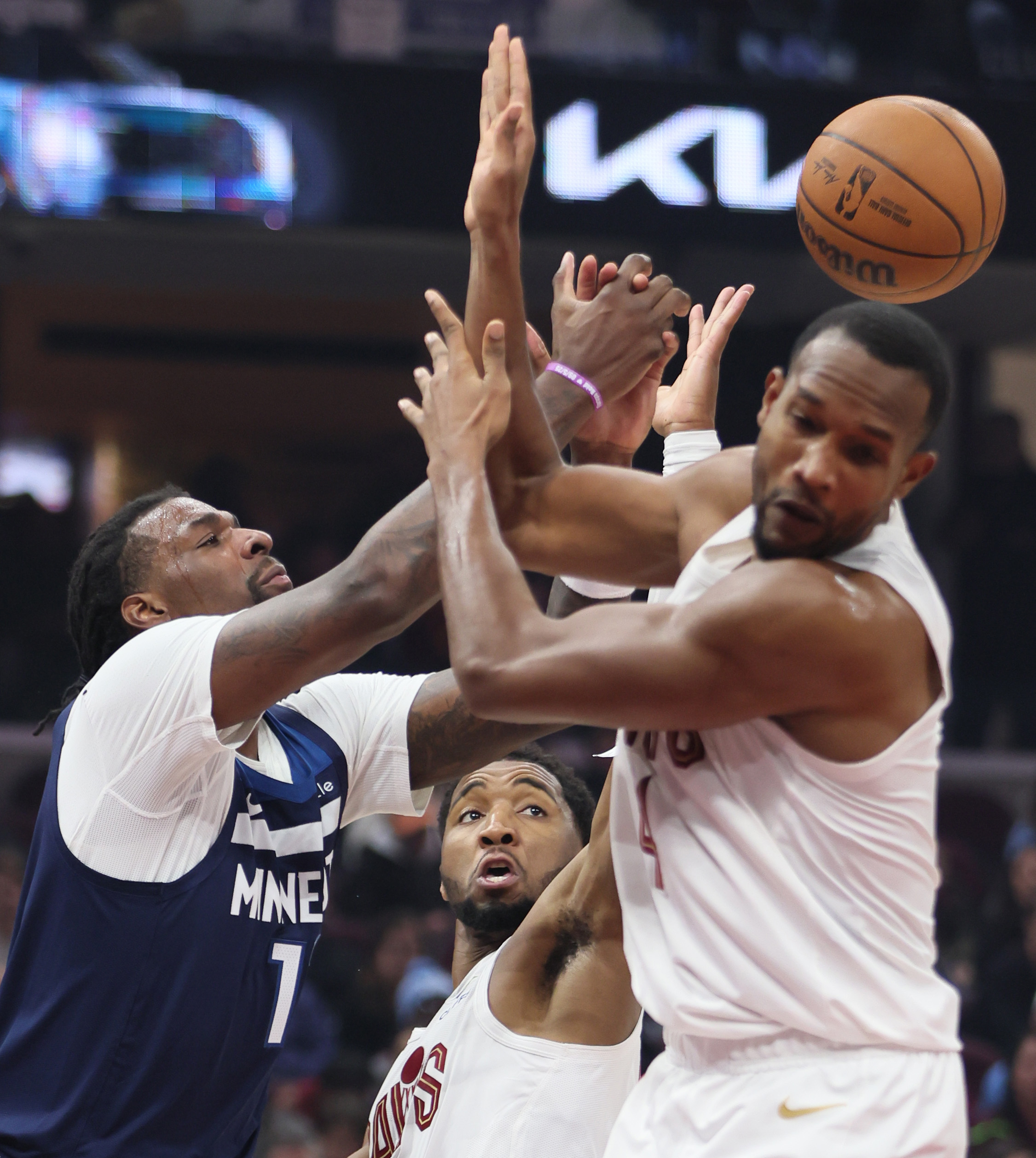 Cleveland Cavaliers center Evan Mobley (R) and Cleveland Cavaliers guard Donovan Mitchell (C) battle Minnesota Timberwolves guard Terrence Shannon Jr. for a rebound in the first half at Rocket Arena. 