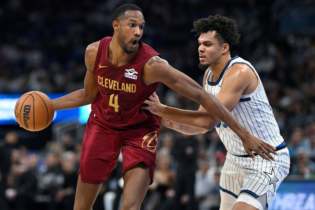Cleveland Cavaliers center Evan Mobley (4) drives to the basket as Orlando Magic forward Noah Penda, right, defends during the first half of an NBA basketball game, Saturday, Jan. 24, 2026, in Orlando, Fla. (AP Photo/Phelan M. Ebenhack)