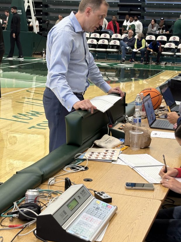 Former Humboldt coach Chris Tifft checks in with old friends at the scorers' table. (Ken McCanless/The Times-Standard)