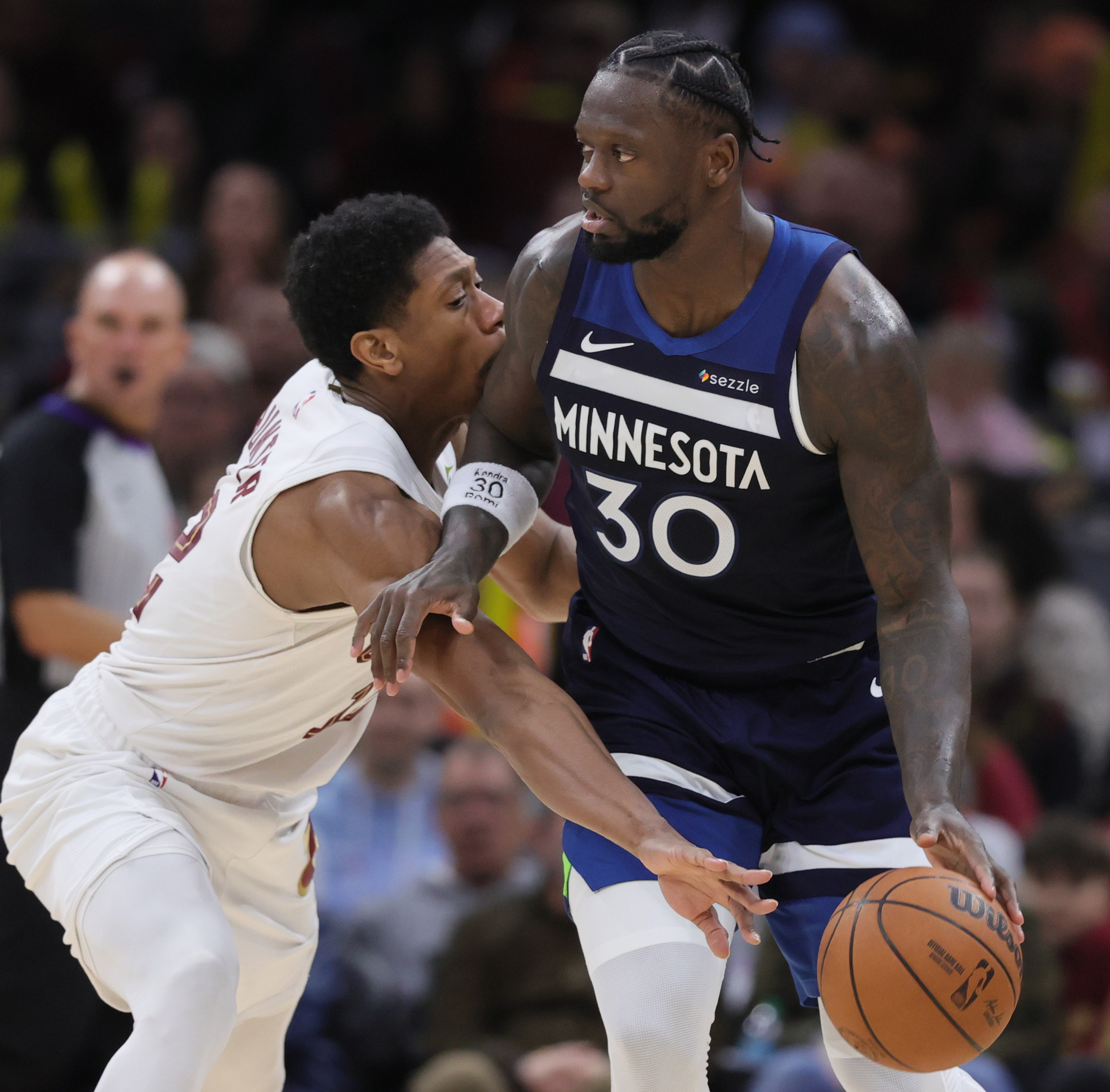Cleveland Cavaliers forward De'andre Hunter swipes at the basketball from the dribble of Minnesota Timberwolves forward Julius Randle in the second half. 