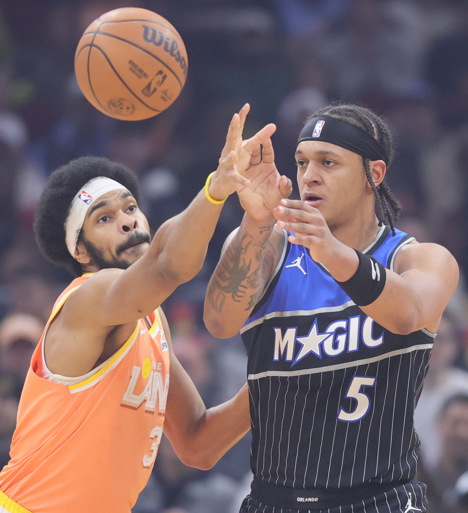 Orlando Magic forward Paolo Banchero (5) gets a pass off as Cleveland Cavaliers center Jarrett Allen tries for the steal in the first half at Rocket Arena. 