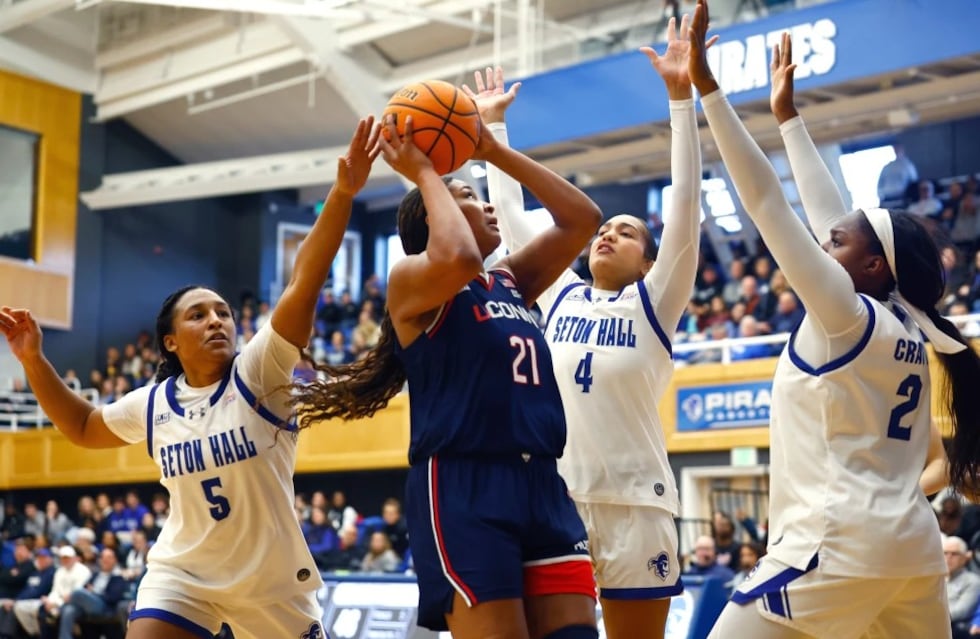 UConn forward Sarah Strong (21) drives to the basket against Seton Hall guards Savannah...
