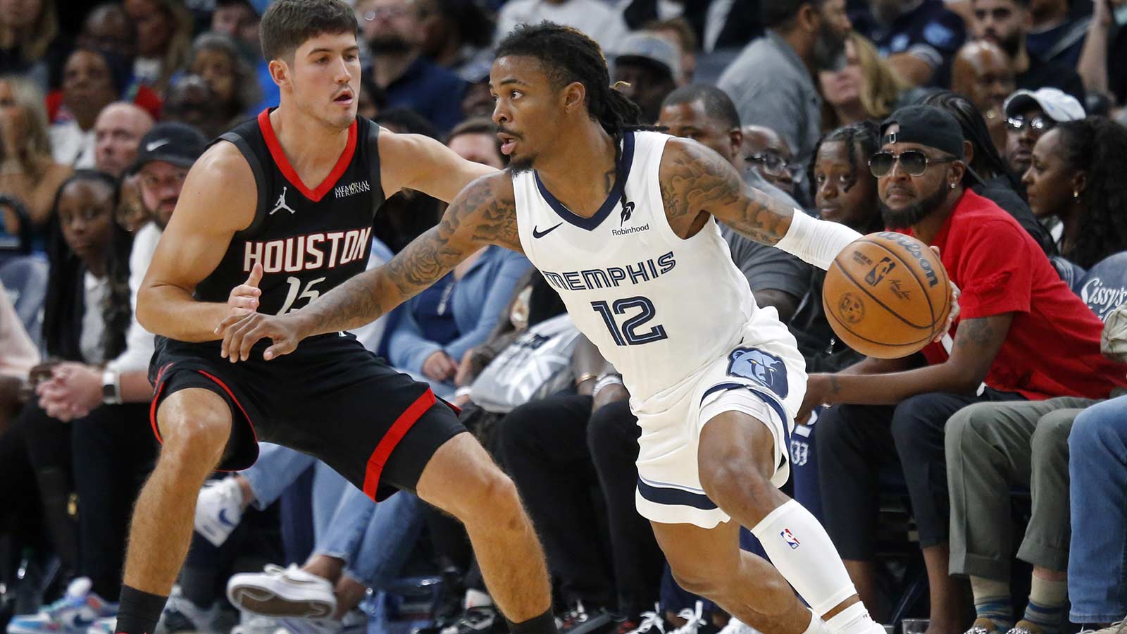 Memphis Grizzlies guard Ja Morant (12) dribbles as Houston Rockets guard Reed Sheppard (15) defends during the fourth quarter at FedExForum. 