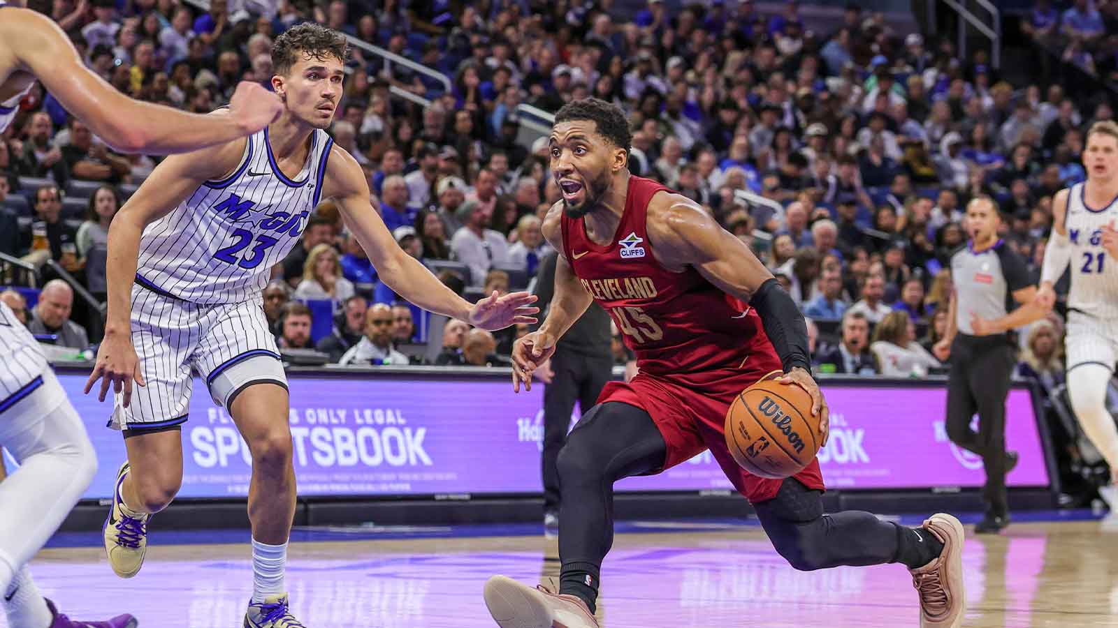 Cleveland Cavaliers guard Donovan Mitchell (45) drives to the basket against Orlando Magic forward Tristan da Silva (23) during the second half at Kia Center.