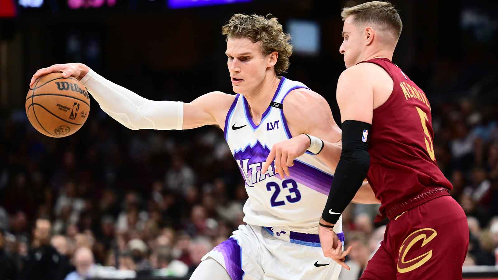 Jazz forward Lauri Markkanen (23) drives to the basket against Cleveland Cavaliers guard Sam Merrill (5) during the second half at Rocket Arena