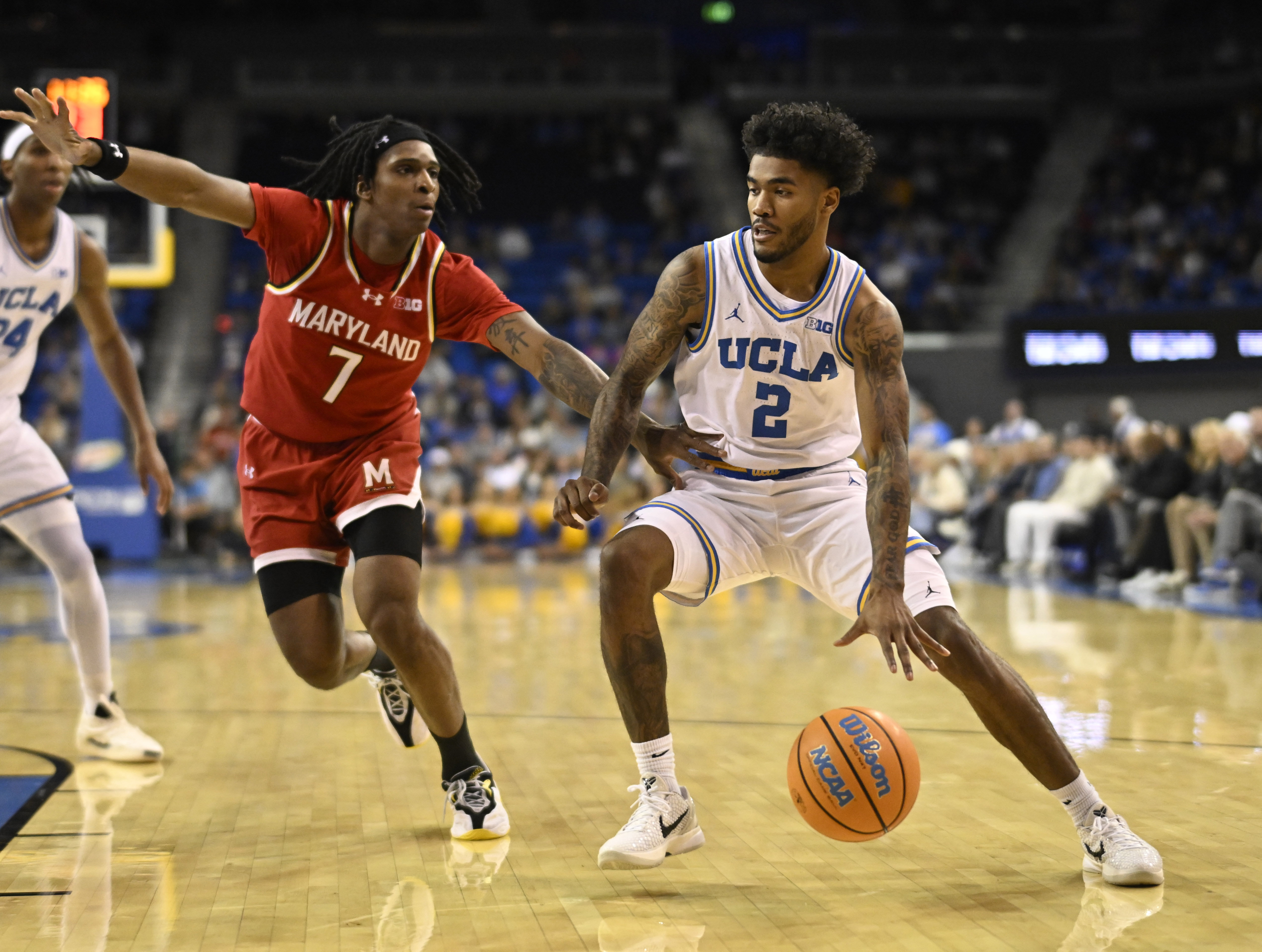 Guard Donovan Dent #2 of the UCLA Bruins drives to...