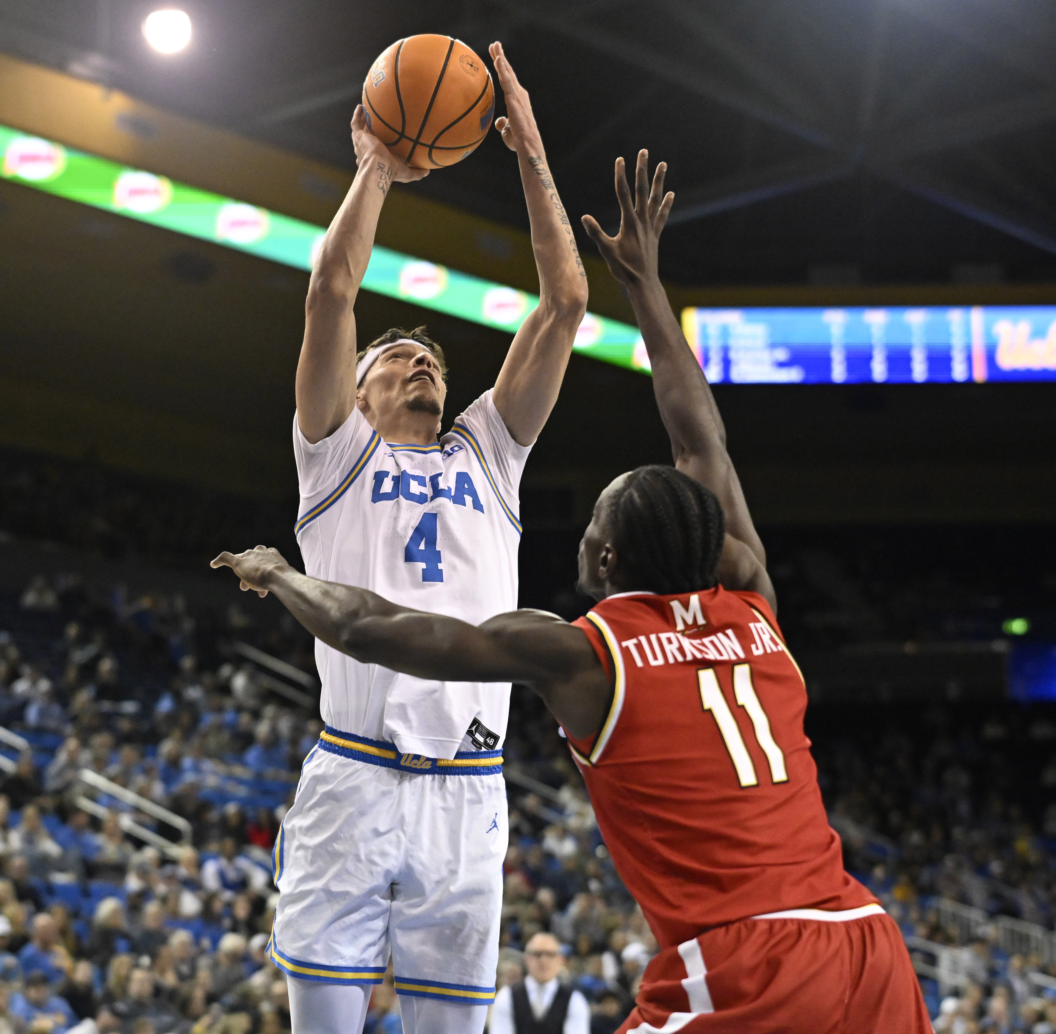 Guard Jamar Brown #4 of the UCLA Bruins shoots over...