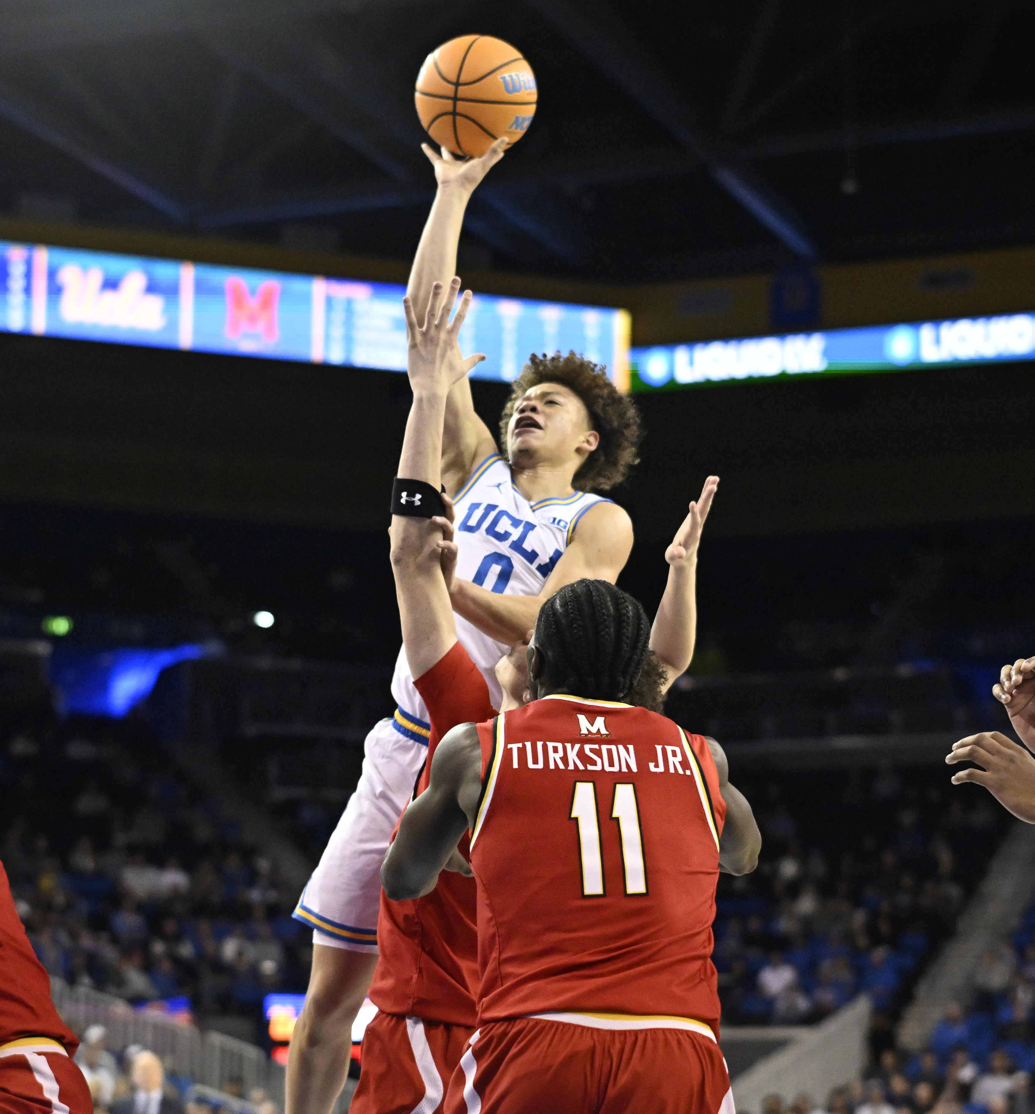 Guard Trent Perry #0 of the UCLA Bruins shoots over...