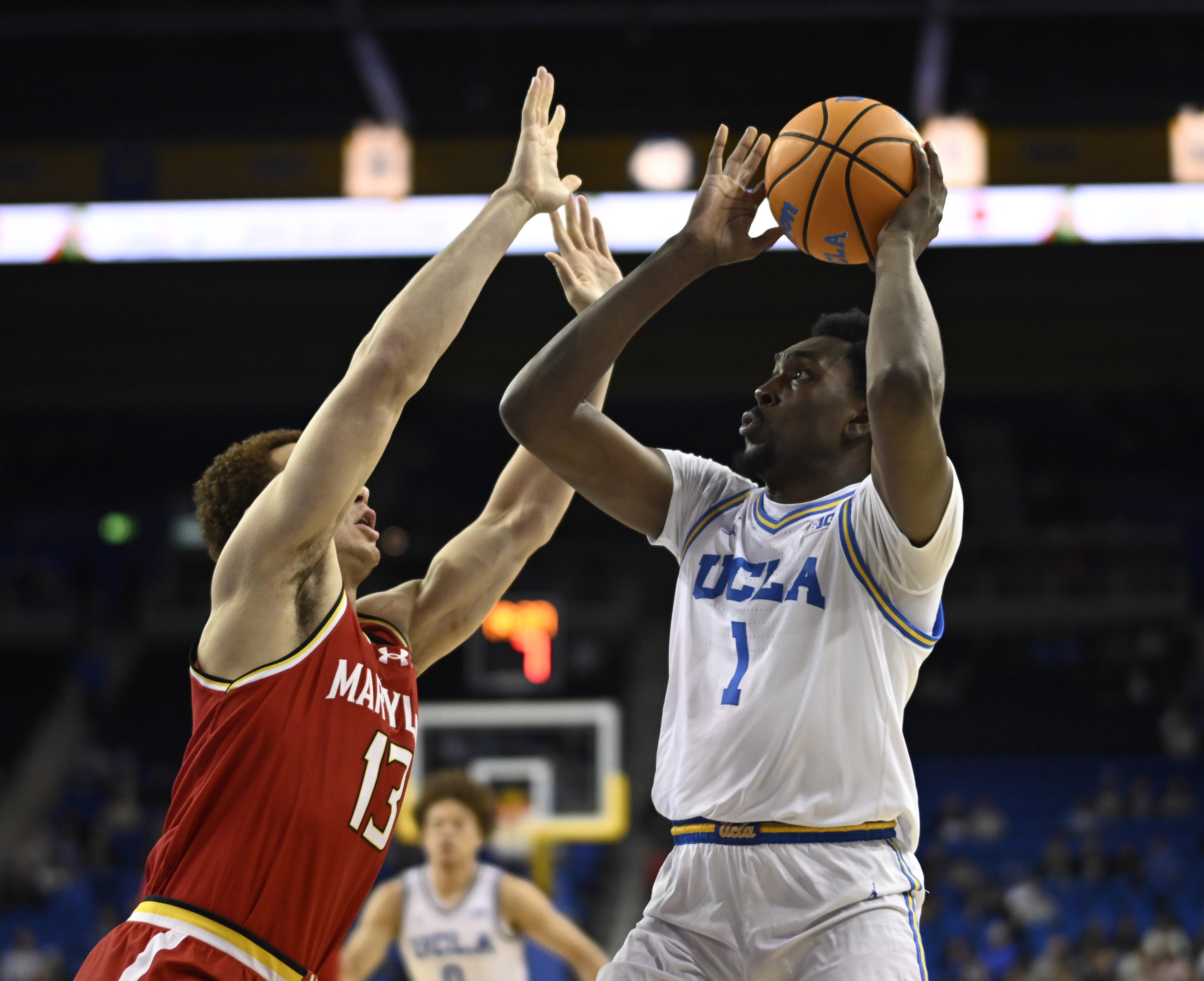 Center Xavier Booker #1 of the UCLA Bruins drives to...