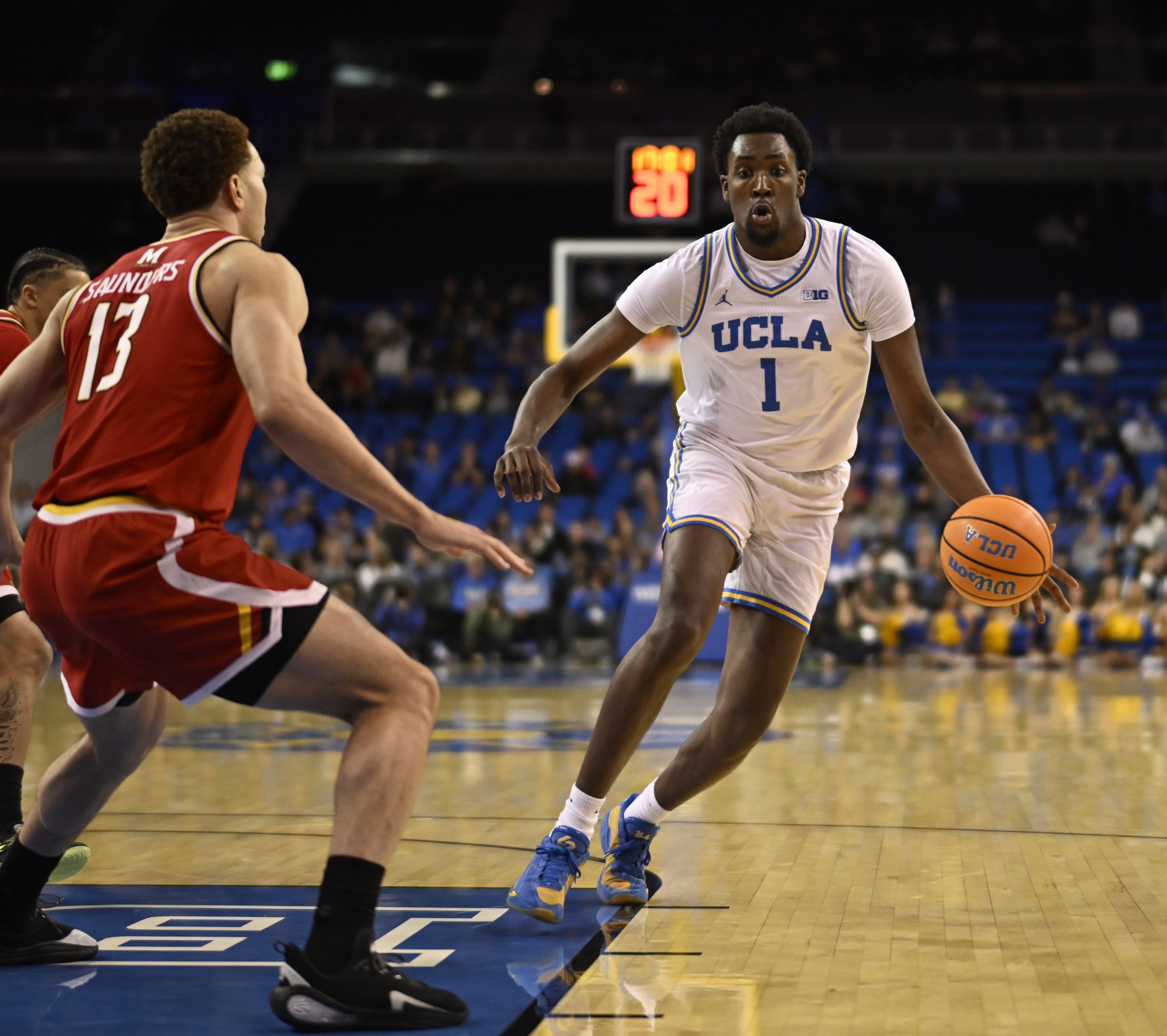 Center Xavier Booker #1 of the UCLA Bruins drives to...