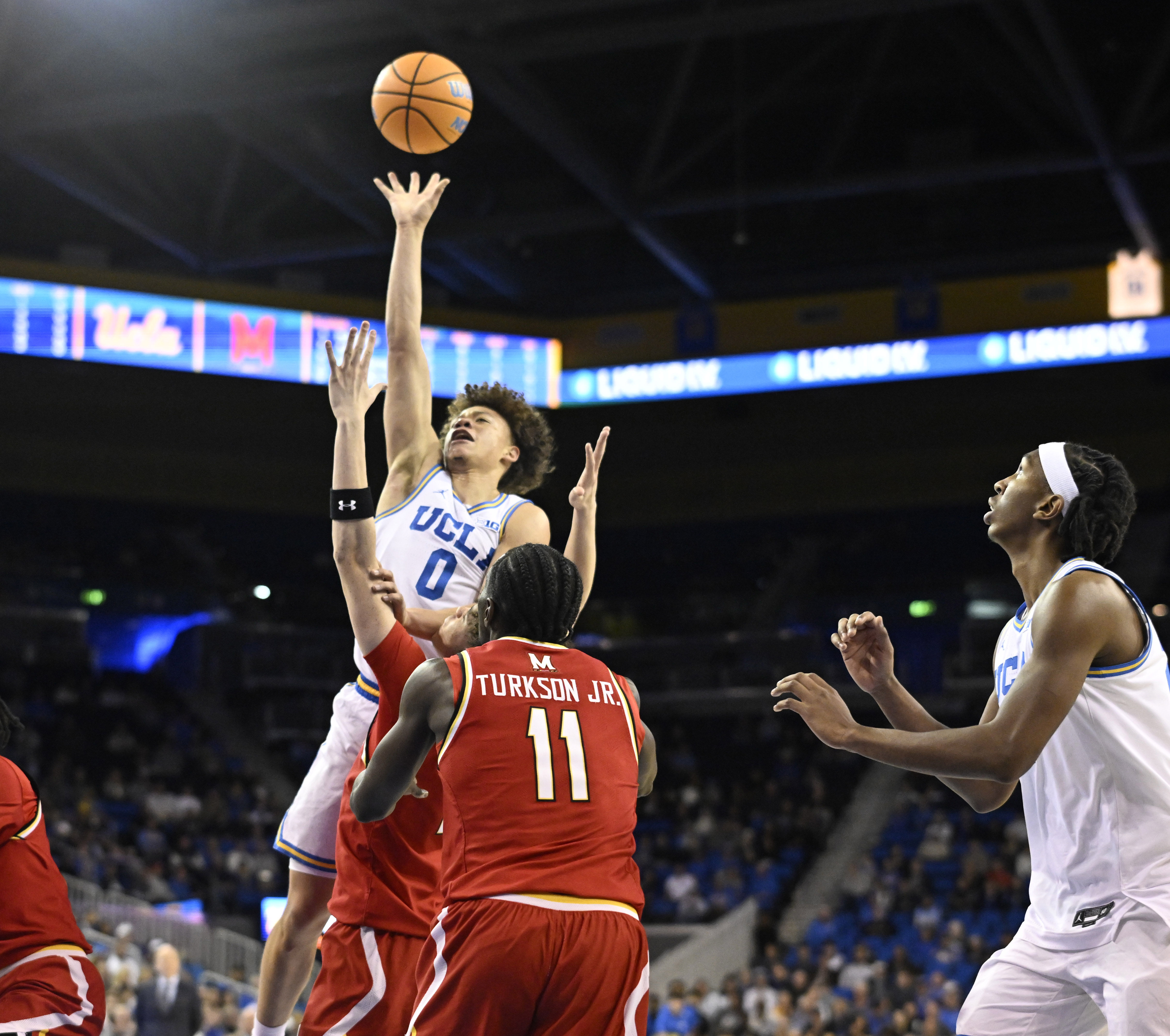 Guard Trent Perry #0 of the UCLA Bruins shoots over...