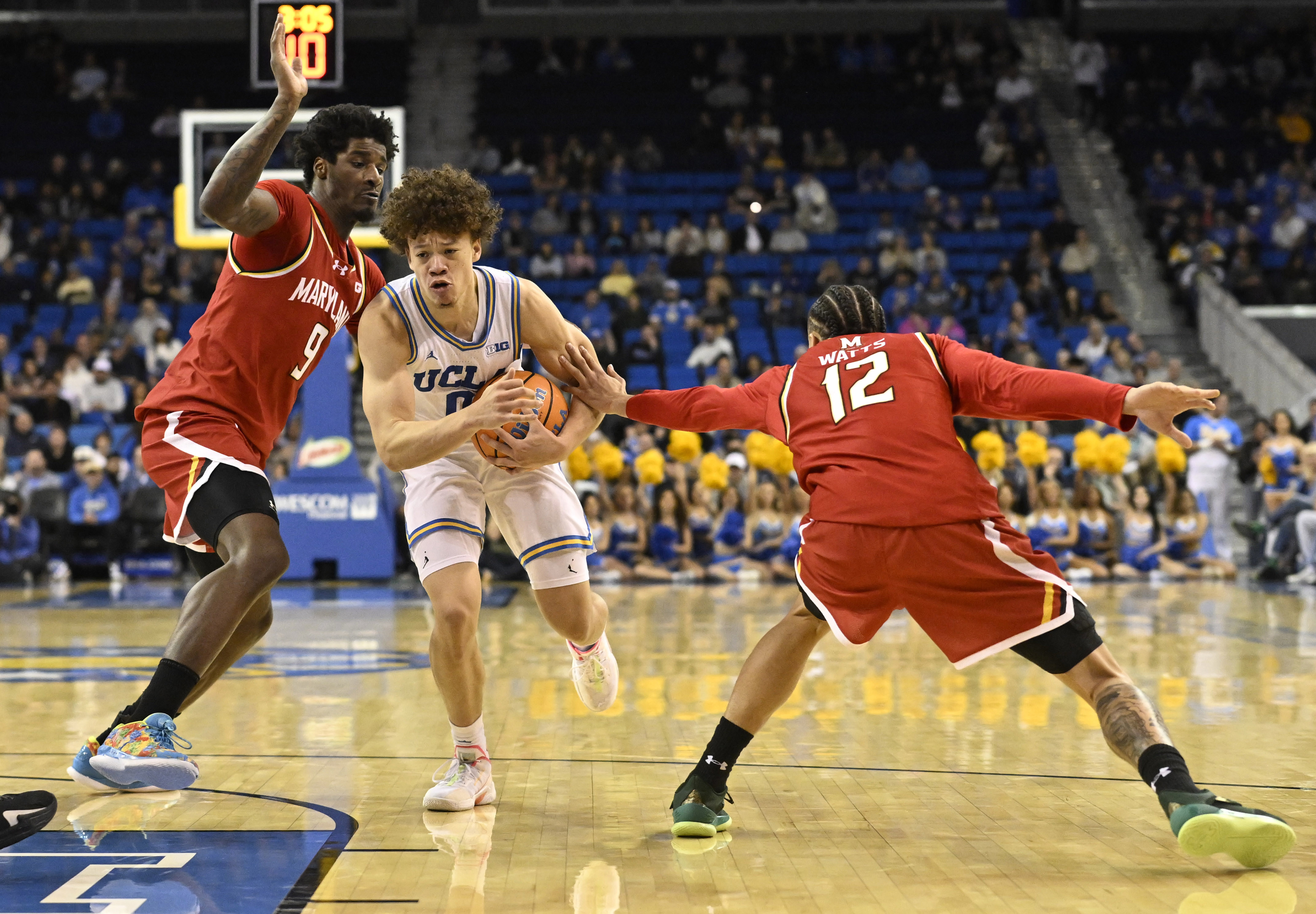 Guard Trent Perry #0 of the UCLA Bruins drives to...