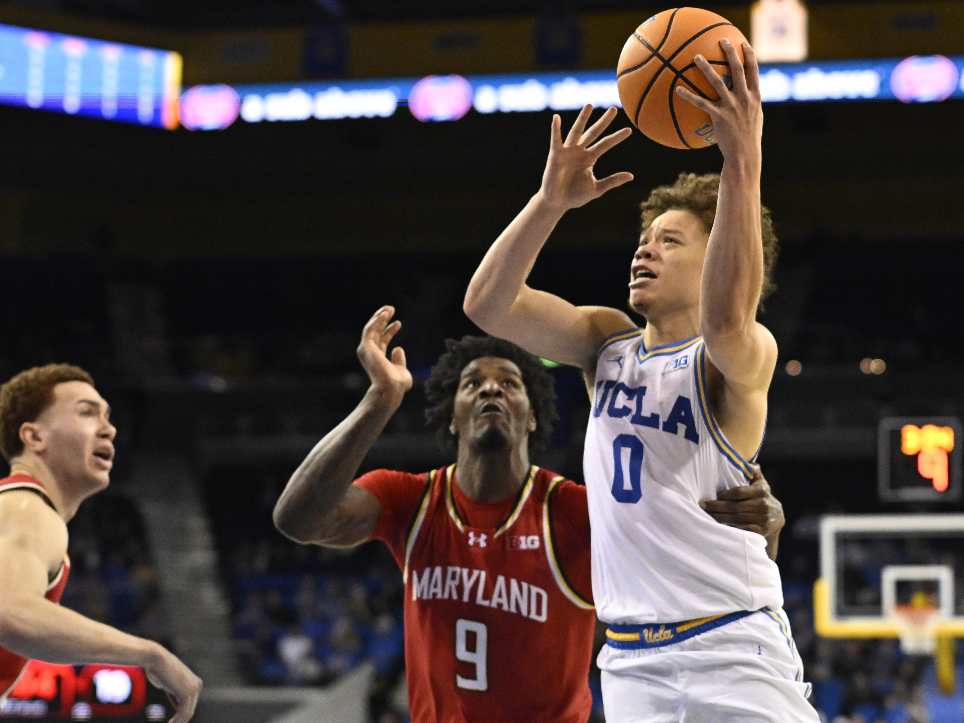 Guard Trent Perry #0 of the UCLA Bruins drives to...