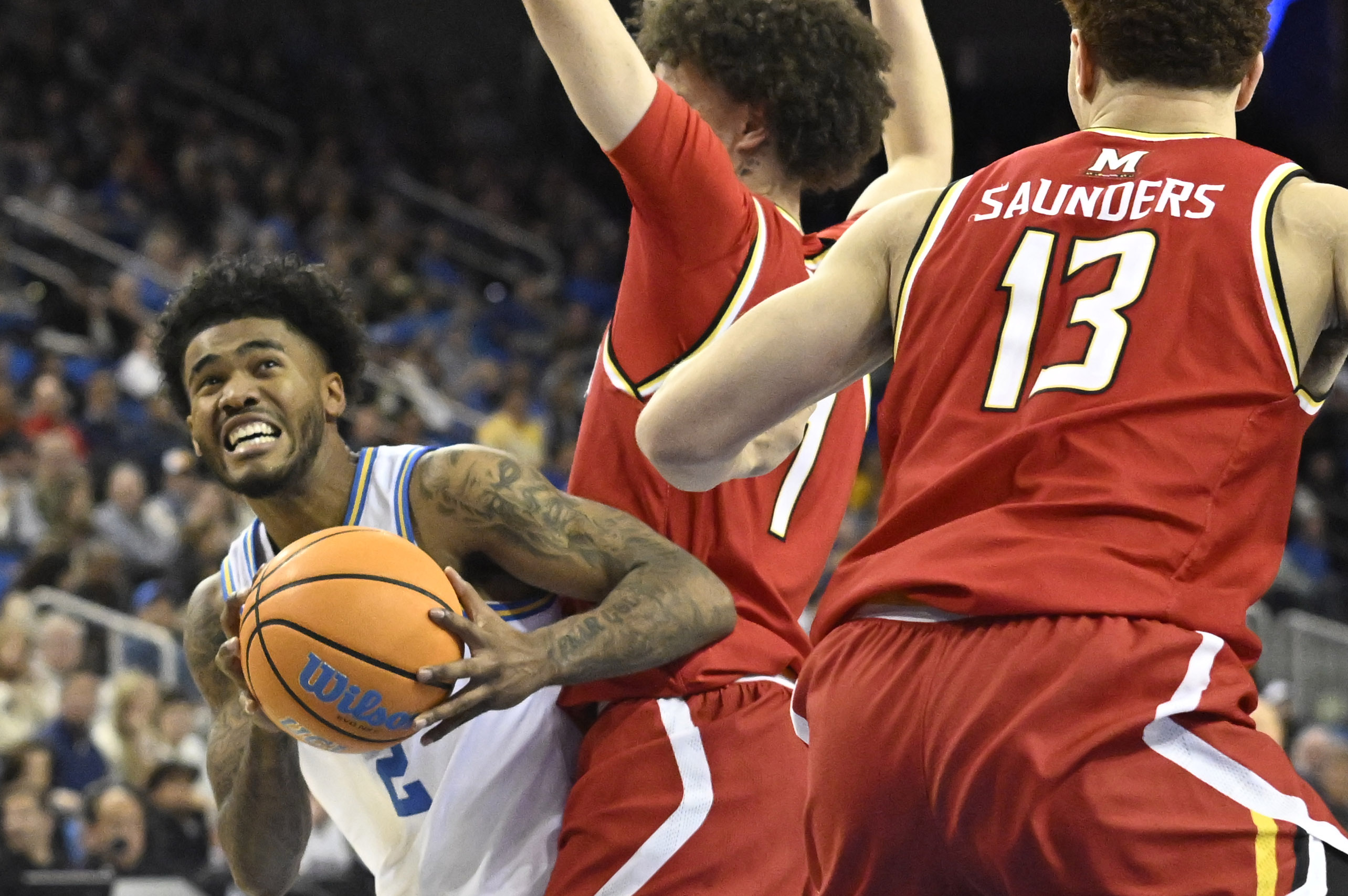 Guard Donovan Dent #2 of the UCLA Bruins drives to...