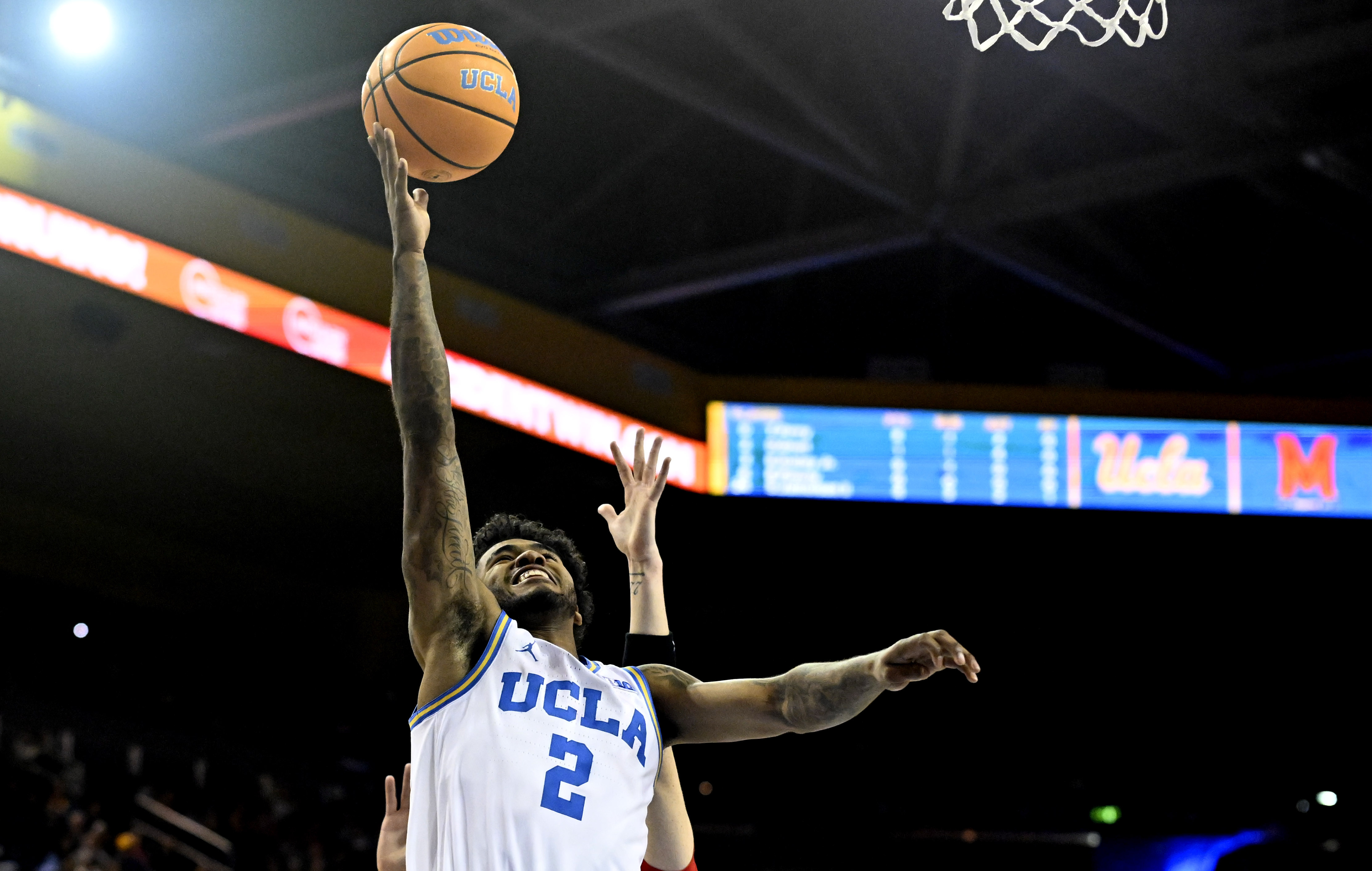 Guard Donovan Dent #2 of the UCLA Bruins drives to...