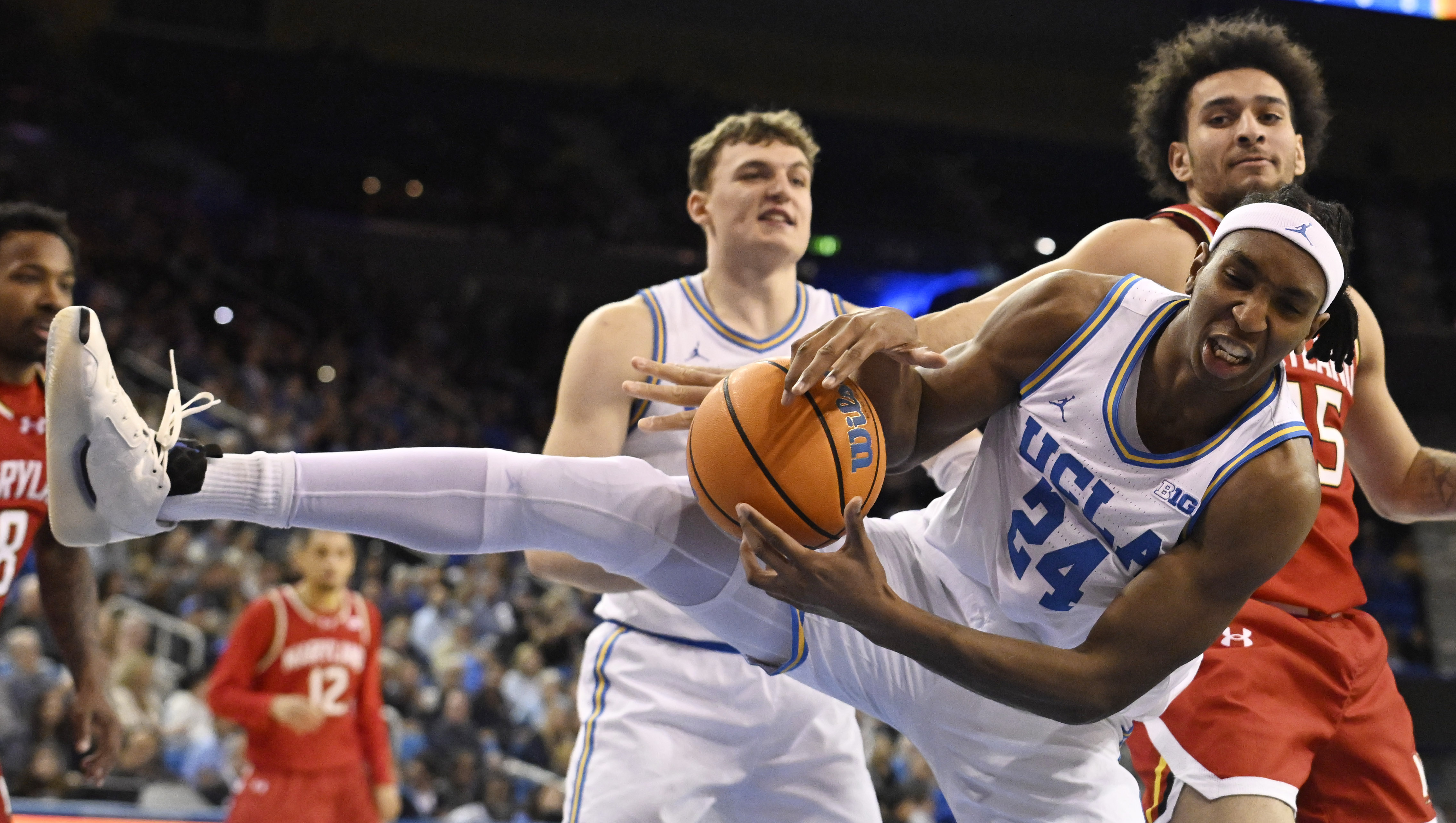 Center Steven Jamerson II #24 of the UCLA Bruins rebounds...