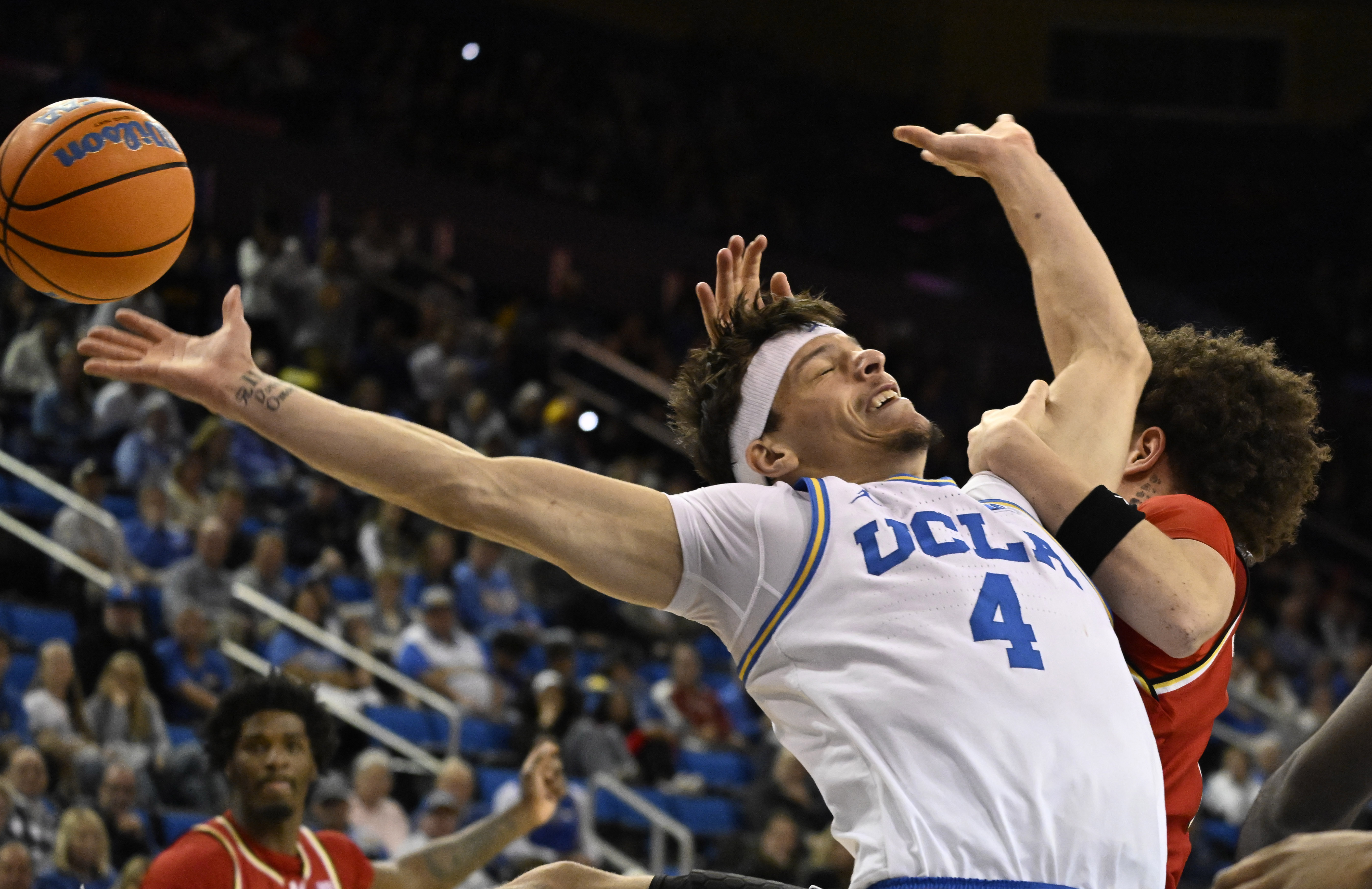 Guard Jamar Brown #4 of the UCLA Bruins reaches for...
